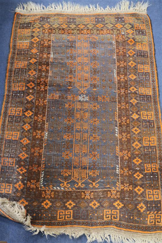 A Persian orange and blue ground rug, 130cm x 90cm